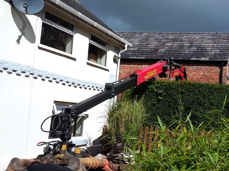 A job reaching over a large hedge saving the customer lots of labour.