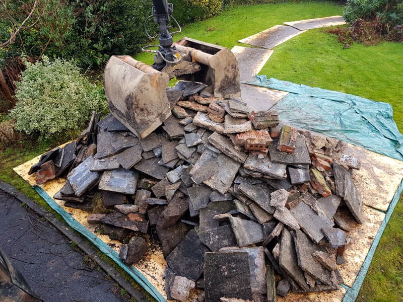 Removing hardcore, tiles, bricks and stones from a site.