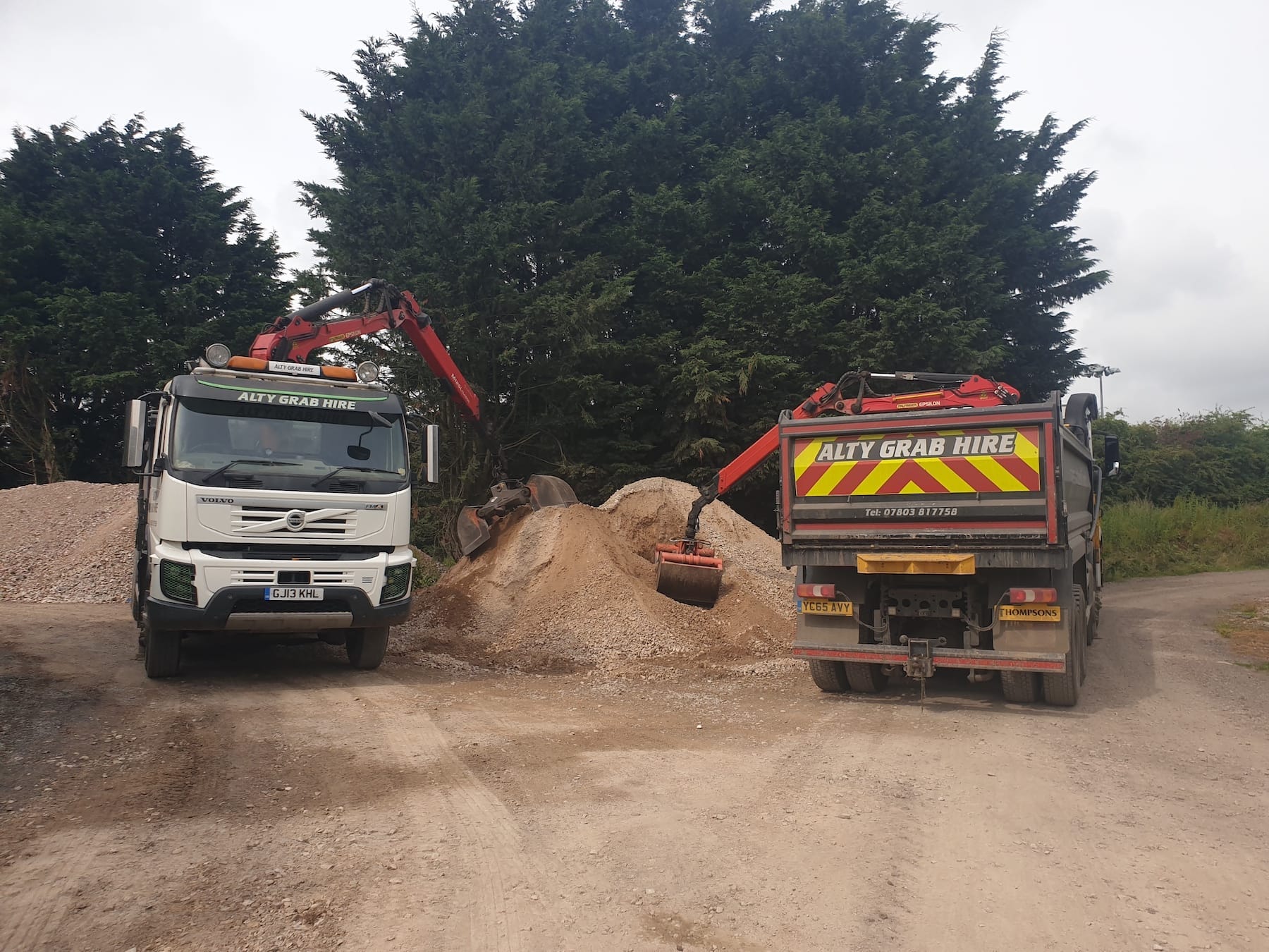 Grab hire truck delivering hardcore and removing waste.